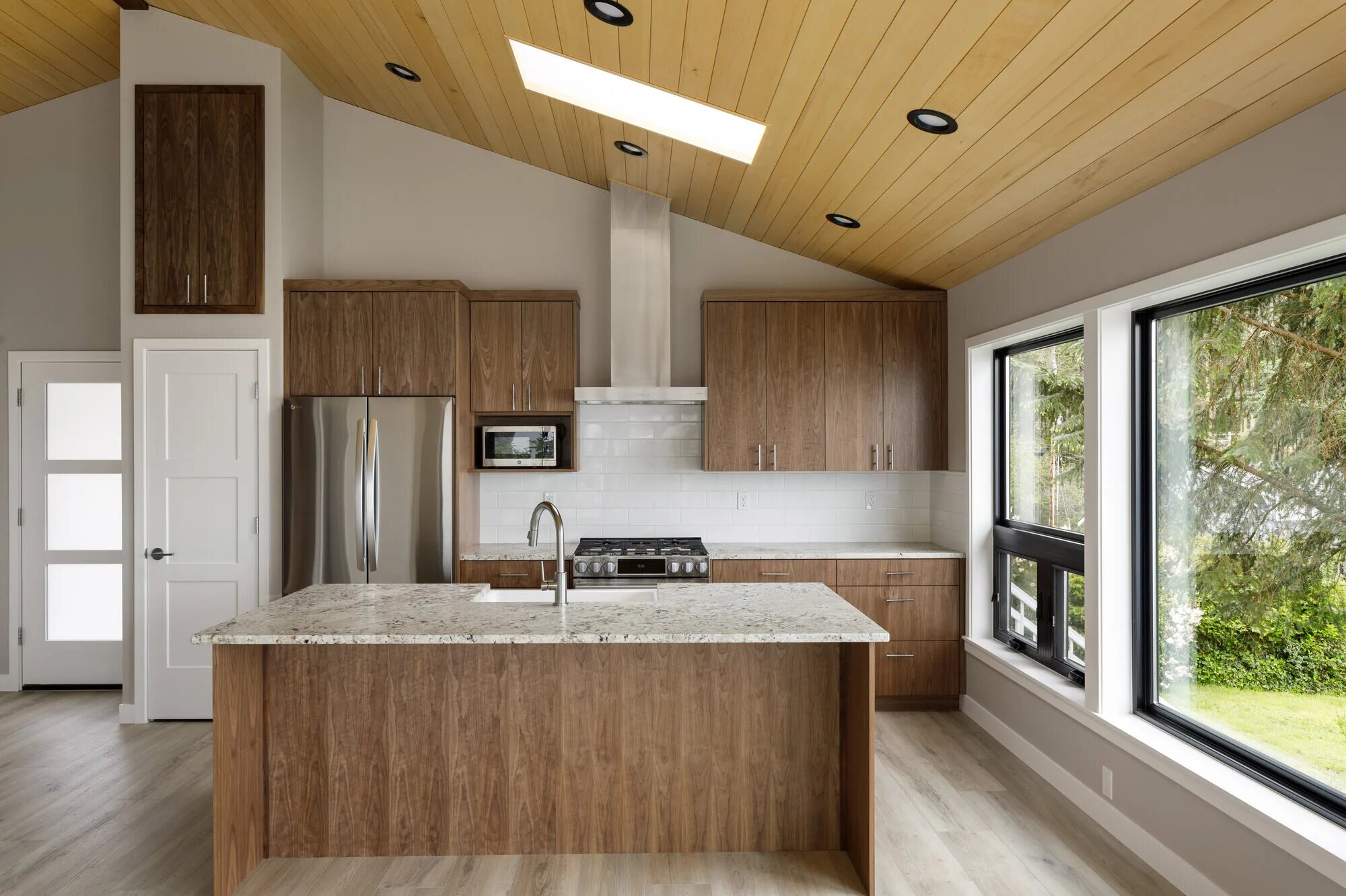 Custom Rosario Cabin kitchen with wood cabinetry and vaulted ceiling in Anacortes, WA