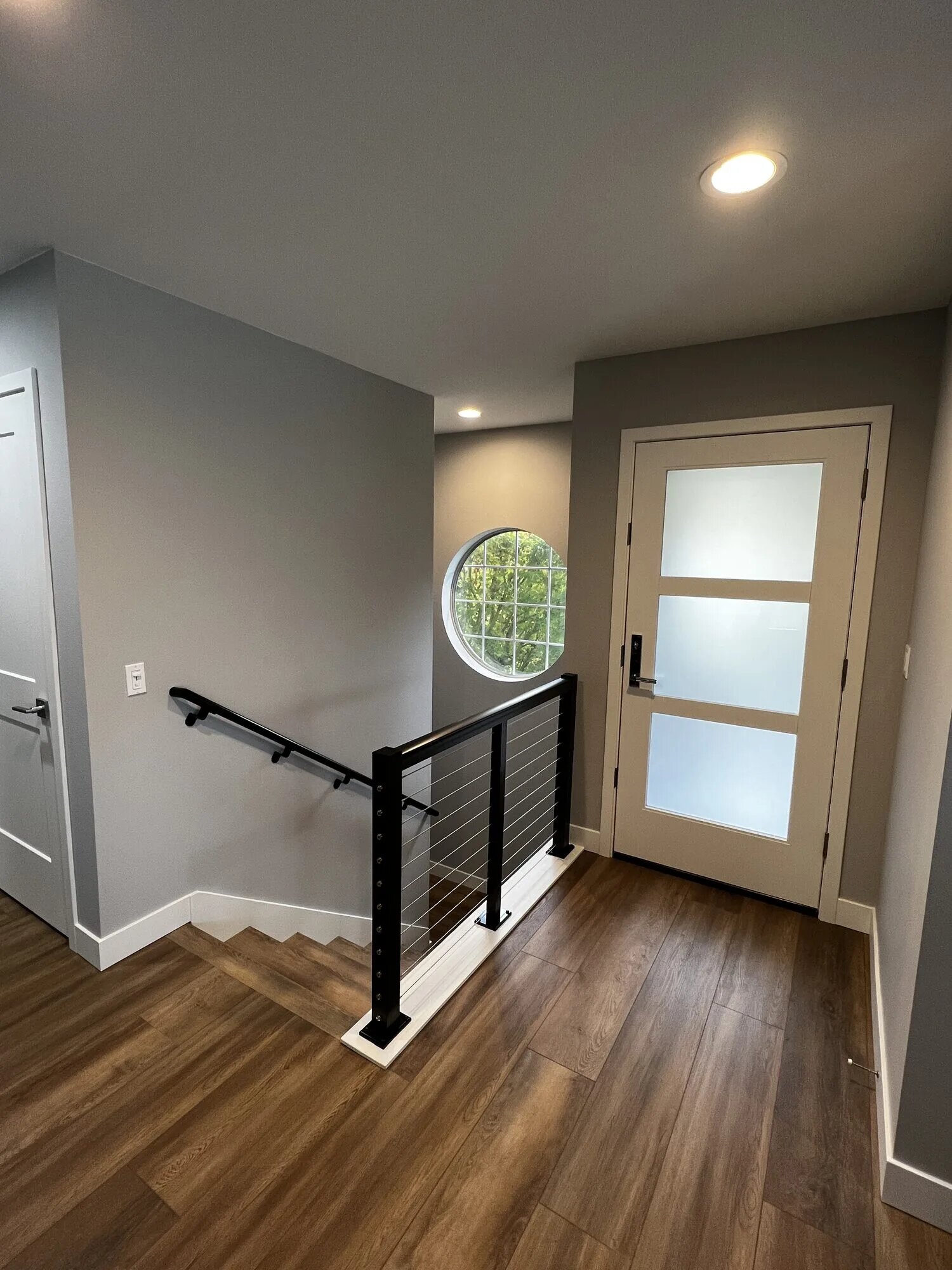 Skyline whole-home remodel featuring modern entryway and cable railing in Anacortes, WA